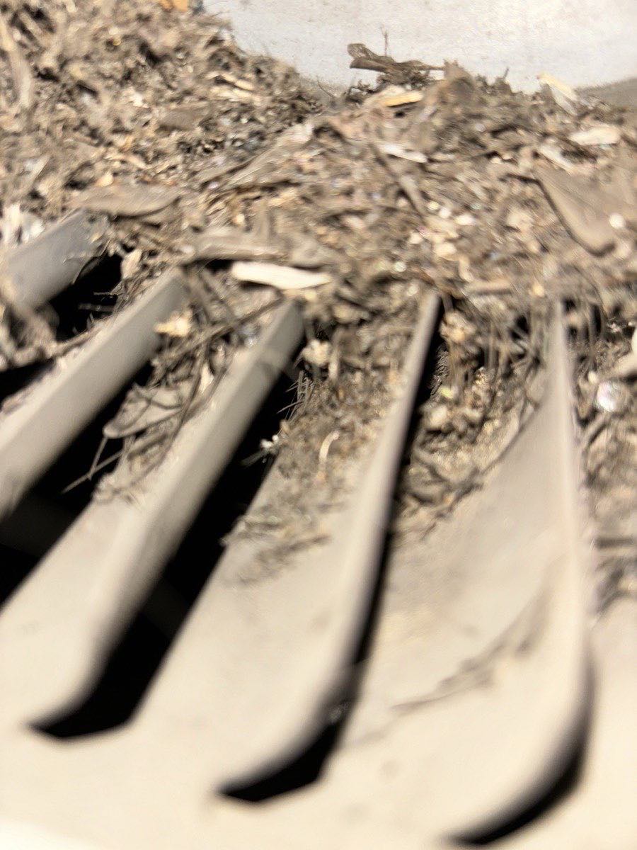A furnace blower wheel with debris packed between the blades