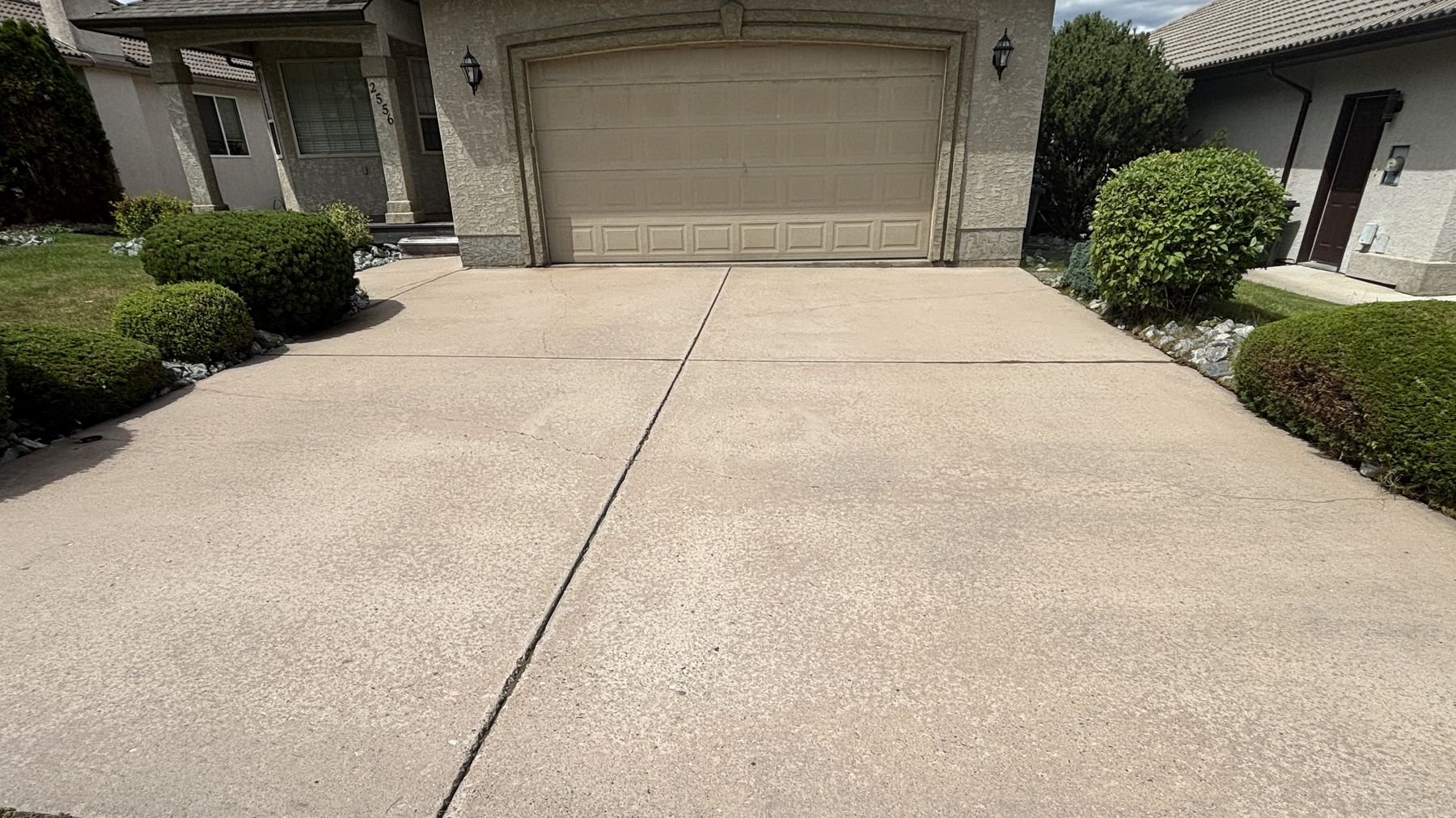 A freshly cleaned concrete driveway at an Okanagan home