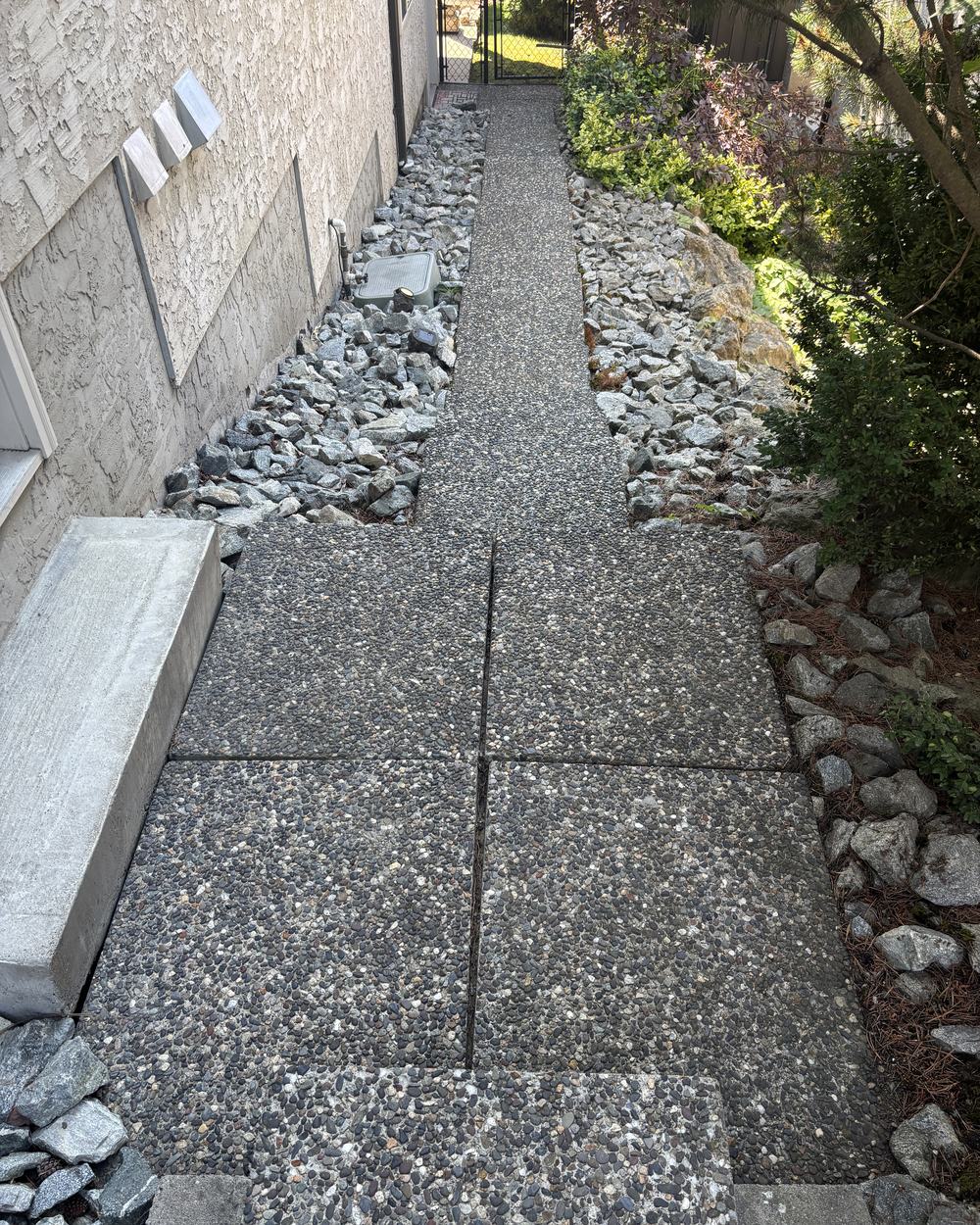 A cleaned aggregate walkway and retaining wall at an Okanagan property